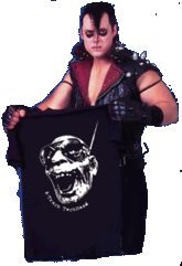 Jerry Only of the Misfits holding a T-shirt with TeckHead's face on it